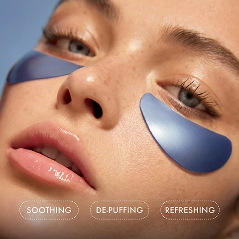 Image 1 - Close-up of a persons face with blue under-eye patches, showcasing smooth skin and a natural look, with the words SOOTHING, DE-PUFFING, and REFRESHING positioned below the image.
Image 2 - A close-up of a skincare product by Summer Fridays, showing text that states 100% saw immediate improvement in skin hydration and 100% saw that their makeup applied more smoothly after one use, with a light blue packaging in the background.
Image 3 - A close-up image of blue Jet Lag® eye patches draped over a silver stick, with droplets forming underneath, and labels indicating Non-sticky, Non-slip, and Ultra-hydrating.
Image 4 - A close-up of a persons face showing blue eye patches under their eyes, with the text designed to comfortably hug the contours of the eye for maximum coverage.
Image 5 - A woman with wet, brown hair poses with her hand on her face, wearing blue eye patches, against a light blue background, with instructions for use visible beside her: 1. Apply to clean, dry undereye area. 2. Leave on for 10 minutes (or longer if desired). 3. Discard after use and pat remaining serum into skin. 4. Use AM or PM—and before makeup application.
Image 6 - A gloved hand holds a translucent blue gel patch against a light background, with overlay text detailing ingredients and their benefits: Glycerin and Hyaluronic Acid help lock in hydration and leave the undereye soft and supple, Niacinamide and Cucumber Extract help comfort and soothe the eye area, Caffeine and Peptides de-puff and firm the eye area.
Image 7 - A collection of skincare products in blue packaging, including Jet Lag® Eye Patches, Jet Lag® Overnight Eye Serum, Jet Lag® Mask, Jet Lag® Skin Soothing Hydration Mist, and Jet Lag® Deep Hydration Serum, with a text description highlighting their benefits.